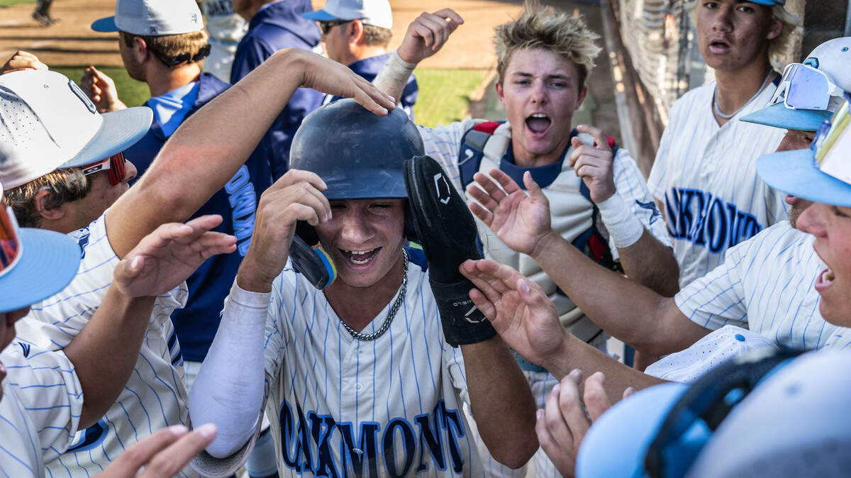 Dom Prado (8) of Oakmont High School is celebrated by teammates after scoring the winning run against Lincoln High School in a CIF Sac-Joaquin Section Division lII baseball semifinal playoff game Monday at Oakmont High School in Roseville.