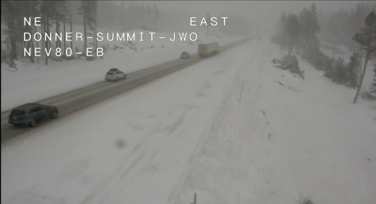 Vehicles drive through snowy conditions on Interstate 80 at Donner Summit around 1 p.m. on Friday, Dec. 13, 2024. 