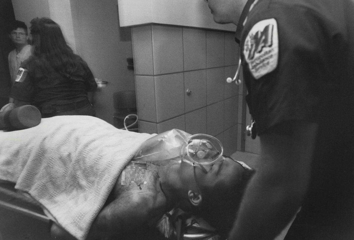 Loi Khac Nguyen, the lone surviving gunman, is wheeled into the emergency room at UC Davis Medical Center on April 4, 1991. 