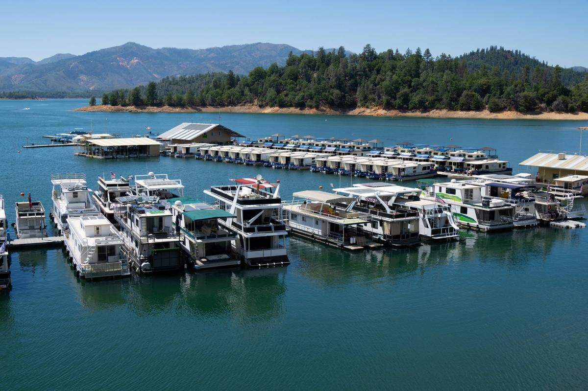Houseboats dock on Shasta Lake at Bridge Bay on Tuesday, Aug. 1, 2023. The lake’s water level is 24 feet below its maximum surface elevation of 1,067 feet.