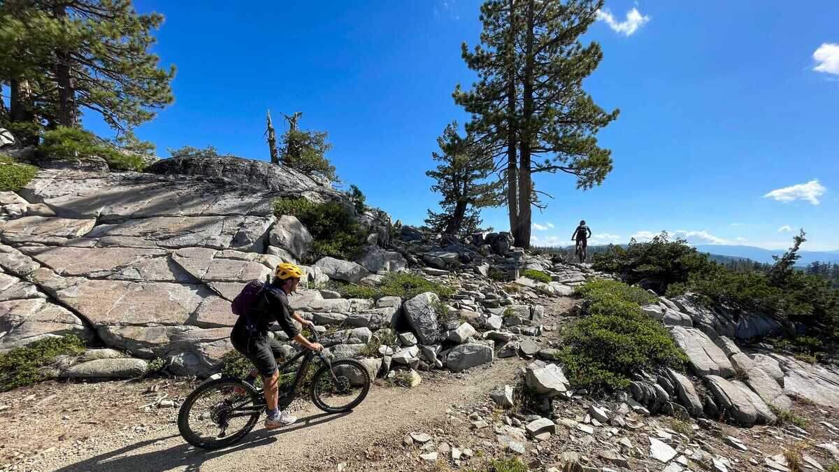 Mountain bikers ride a trail in Tahoe National Forest in September 2023. The U.S. Forest Service has imposed Stage 1 fire restrictions through Oct. 31 because of increasing wildfire danger, limiting campfires to designated recreation sites and announcing plans to use infrared-equipped drones to detect illegal campfires over the Fourth of July weekend.