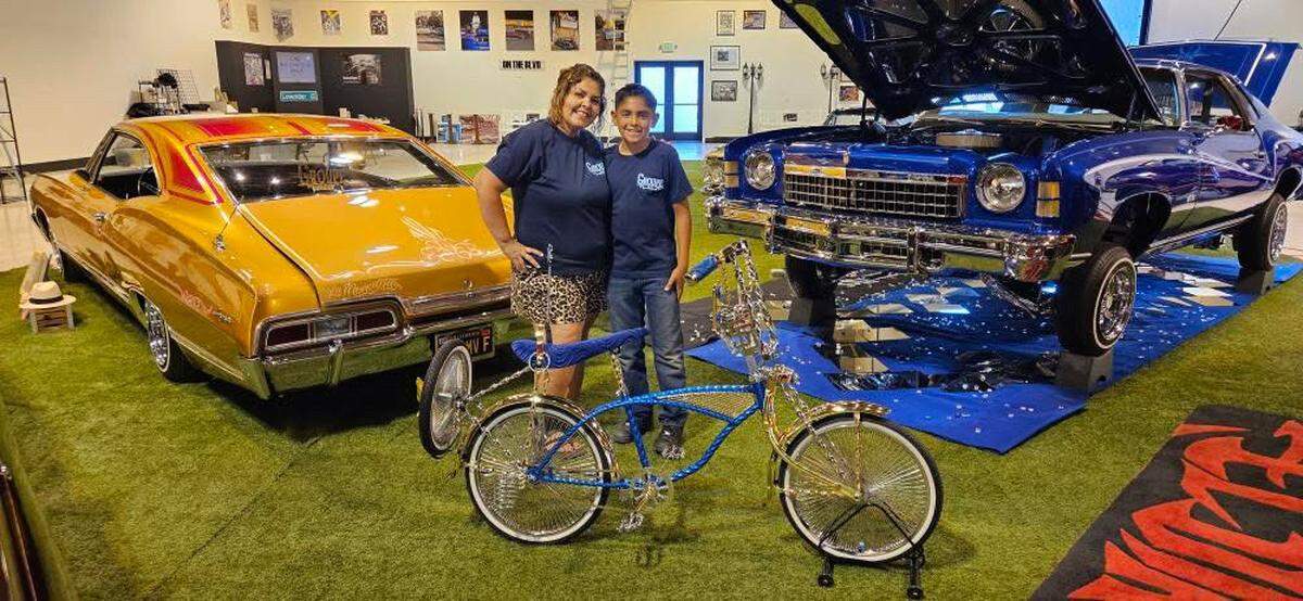 Adrianna Echeverria, left, and her son Jayden Lopez pose with Lopez’s mini bike at the 2025 California State Fair. The bike is on display alongside Echeverria’s 1967 Chevrolet Impala lowrider until July 27.