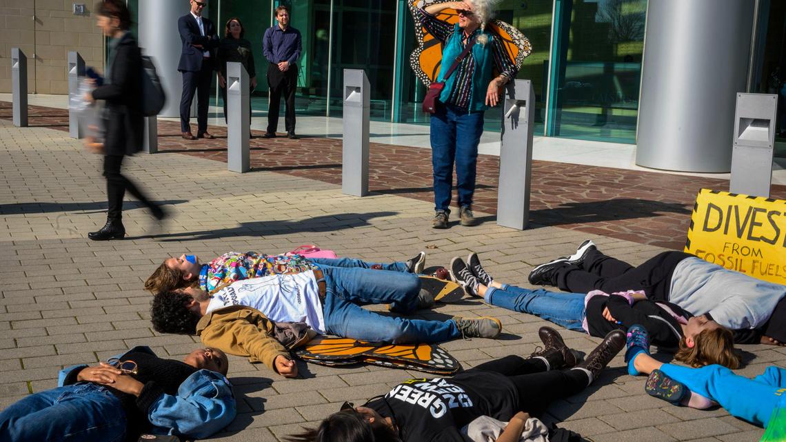 Student activists with Youth vs Apocalypse participate in a “die-in” outside the CalSTRS building in West Sacramento on Thursday, Jan. 30, 2020, calling for the divestment of CalSTRS funds from fossil fuel companies, claiming it will affect climate change and their future.