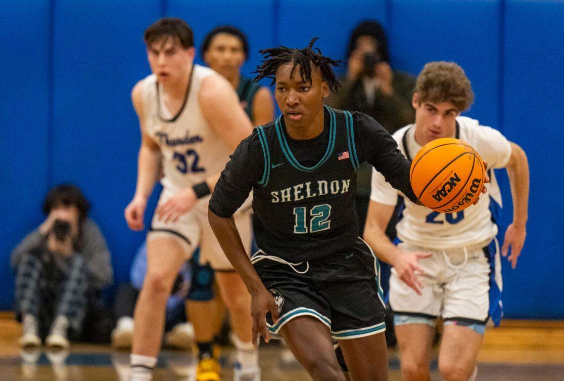 The Sheldon Huskies’ Zion Johnson (12) brings the ball down court against the Rocklin Thunder during a 2024 CIF Sac-Joaquin Section boys basketball Division I quarterfinal game.