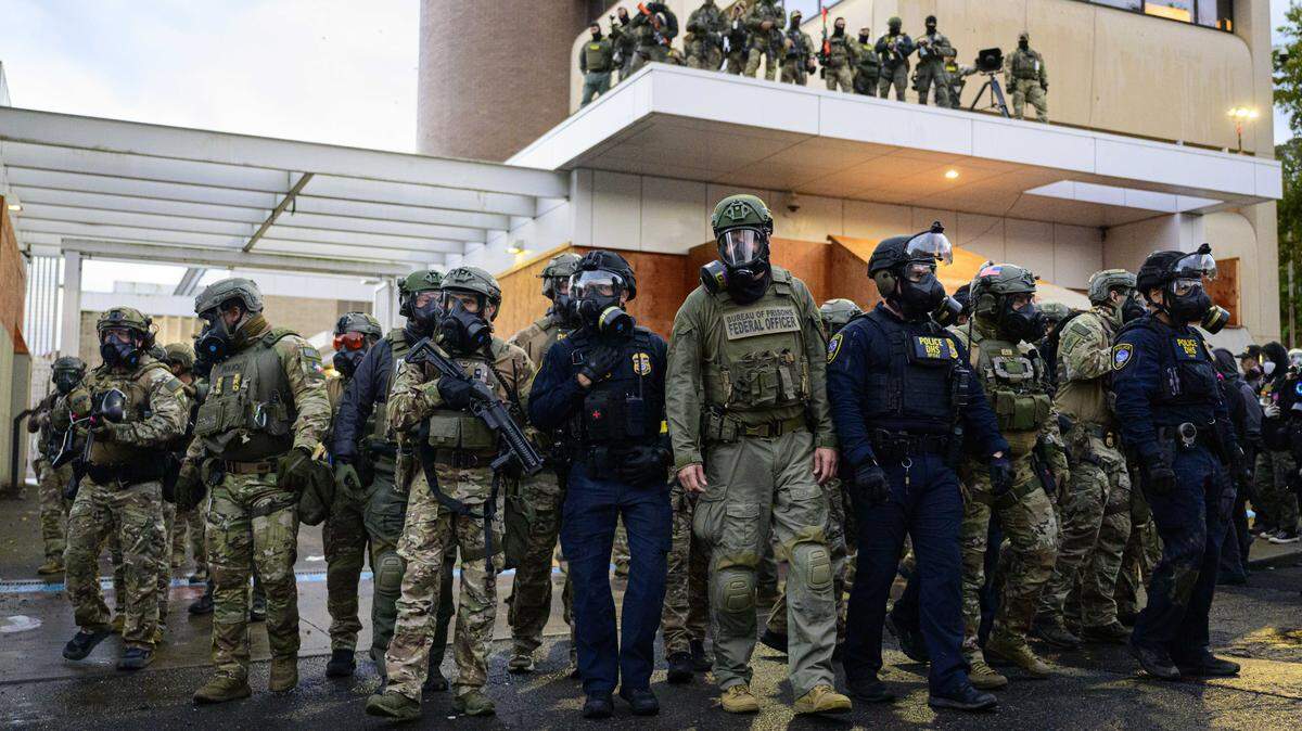 Federal agents clash with protesters at the Immigration and Customs Enforcement building on Oct. 12 in Portland, Ore.