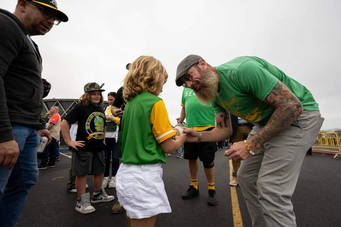 Former Oakland Athletics pitcher Dallas Braden meets with fans outside of the Oakland-Alameda County Coliseum before the A’s and Texas Rangers played the final game in Oakland on Thursday.