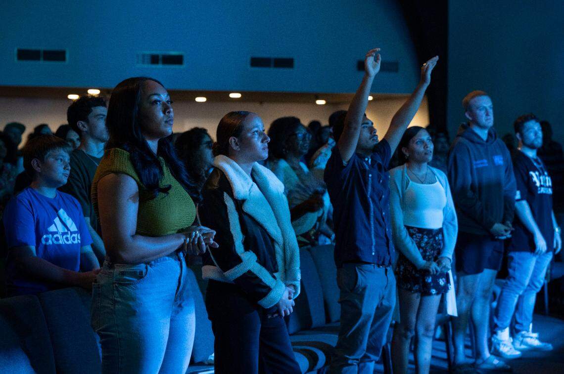 New Season Church congregation members stand during worship last Sunday.