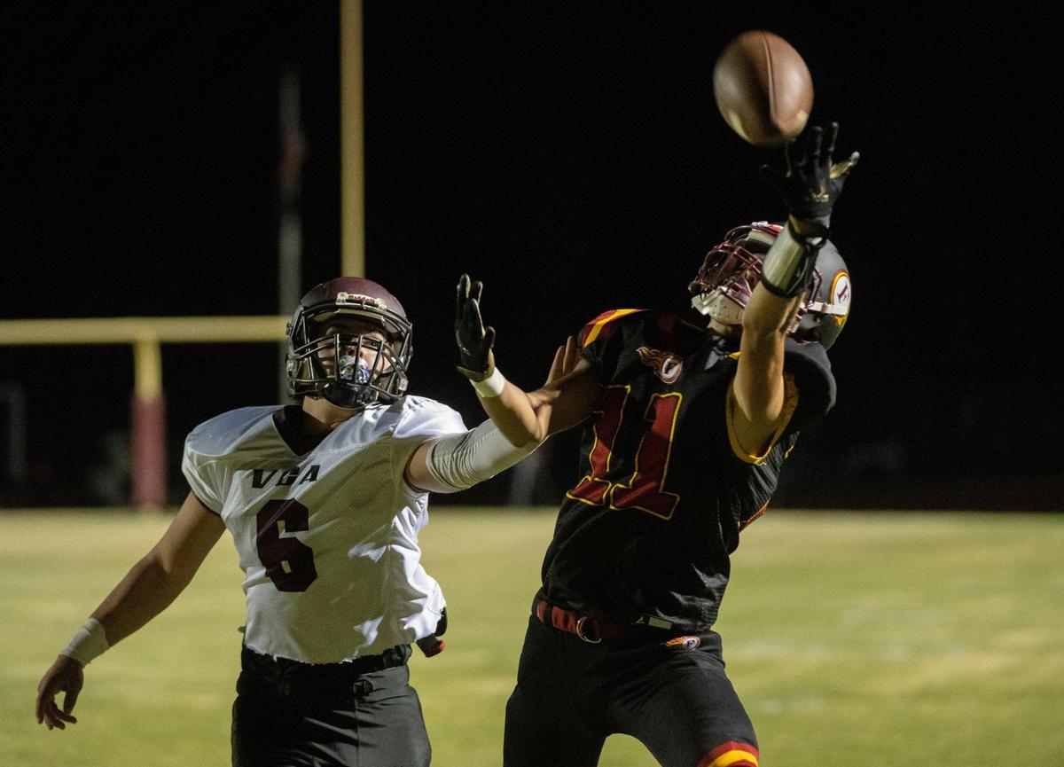 Foresthill Wildfires Damian Napoles (11) makes a touchdown catch defended by Valley Christian Lions Jackson Nichols (6) in the second quarter during a game at Foresthill High School in Foresthill on Friday. It was the Wildfires first home game since the Mosquito Fire.