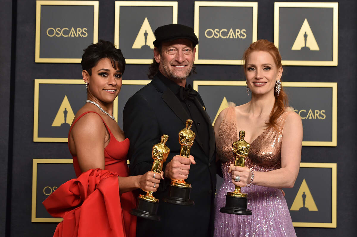 Ariana DeBose, from left, winner of the award for best performance by an actress in a supporting role for “West Side Story, Troy Kotsur, winner of the award for best performance by an actor in a supporting role for “CODA”, and Jessica Chastain, winner of the award for best performance by an actress in a leading role for “The Eyes of Tammy Faye,” pose in the press room at the Oscars on Sunday, March 27, 2022, at the Dolby Theatre in Los Angeles. (Photo by Jordan Strauss/Invision/AP)