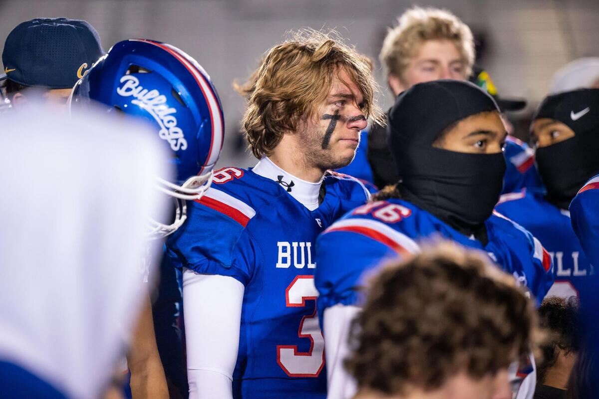 Folsom Bulldogs free safety Brennan Warren (36) and teammates take in head coach Paul Doherty’s words at the end of their close loss to De La Salle in the CIF Northern California Regional Championship football game Friday at Folsom High School. De La Salle now heads to the Division I-AA state championship.