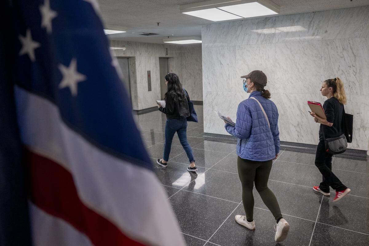 Heidi Phipps, left, provides a tour of the John E. Moss federal building in downtown Sacramento for new volunteers before immigration court hearings on Thursday, July 24, 2025.