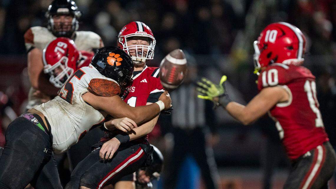 Winters Warriors quarterback Lane Brown (11) takes a hit from Arcata Tigers’ Neiko Bryson (55) during a  game in 2024, in Winters. Brown accounted for three touchdowns to lead Winters past Minarets 26-12 in the CIF Northern California Division 6-A championship on Saturday.