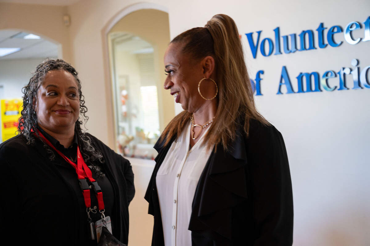 Anna Cornelius, program manager at Open Arms, left, talks with Jade, a program participant, at the Volunteers of America’s offices in Sacramento earlier this month. Open Arms serves individuals who are HIV-positive or living with AIDS.