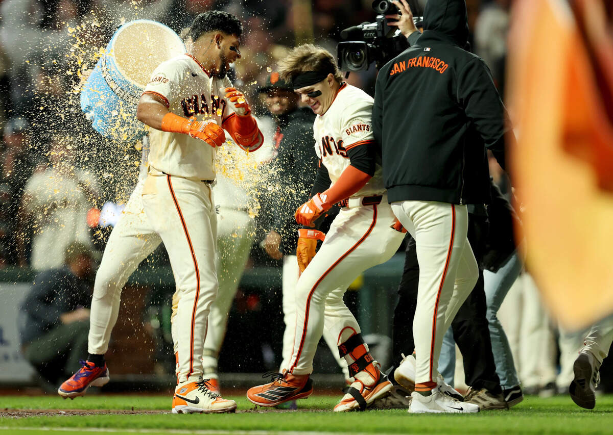 The San Francisco Giants’ Victor Bericoto is doused with a sports drink by teammate Willy Adames as they celebrate his walk-off home run with in the ninth inning Wednesday at Oracle Park in San Francisco.