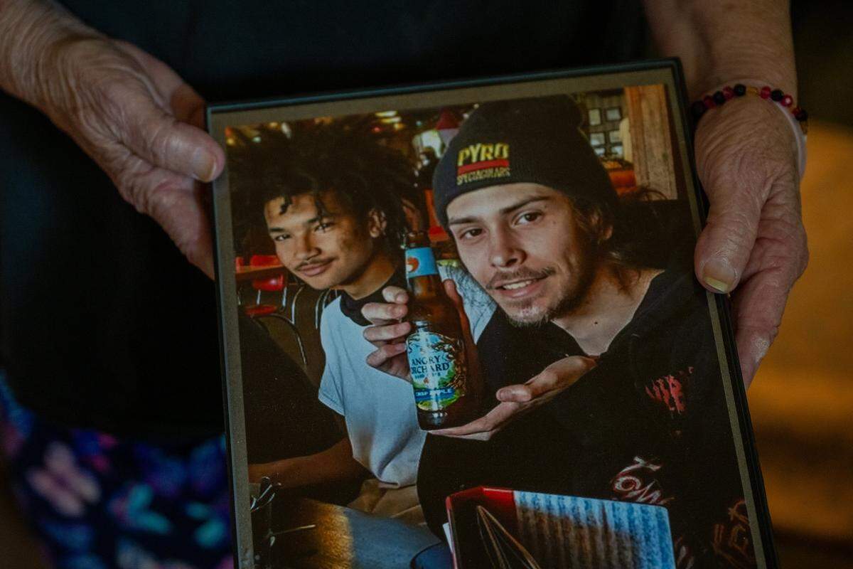 Cheryl Pringle holds a picture of her son, Andrew Pringle, at right, in May. “He spent a lot of time in his room — he wasn’t the kind of kid who was outside getting into trouble,” she said.