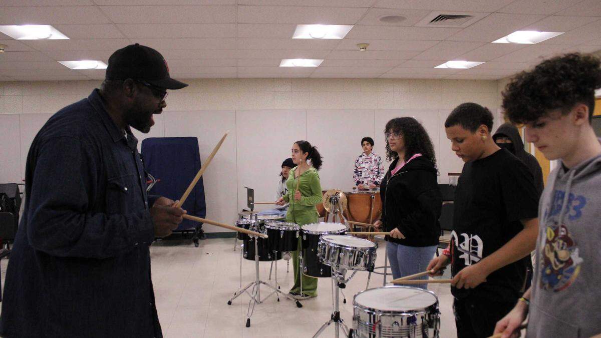 Mills Middle School music instructor Jimmie Adams instructs his snare, timpani and tenor drummers, right to left, Zayne Starks, Patrick Brewer, Kierah McCants, Rustam Azami and Scarlett Zendejas during a double and triple beat exercise on Wednesday, Dec. 7, 2022.