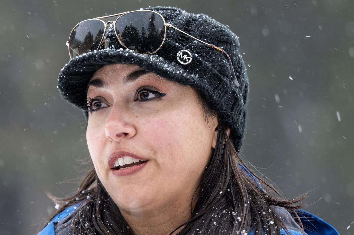 Snow falls as California Department of Water Resources hydrometeorologist Angelique Fabbiani-Leon warns against driving to the Sierra after she and her co-workers conducted a monthly snow survey at Phillips Station in El Dorado County on Thursday, Feb. 29, 2024. The National Weather Service has issued a blizzard warning.