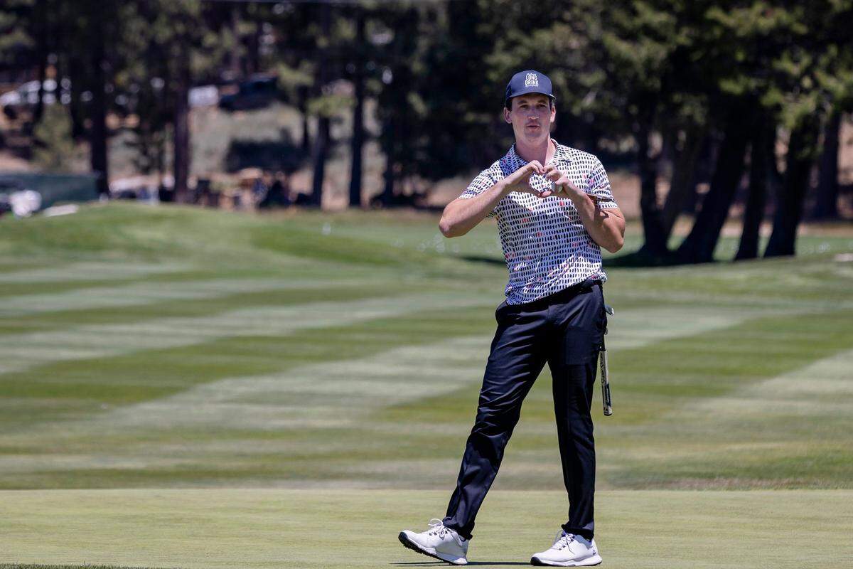 Actor Miles Teller, who stars in the new Top Gun movie, makes a heart to the fans at the eighteenth hole during the American Century Celebrity Golf Championship Tournament on Sunday, July 10, 2022, at Edgewood Tahoe Golf Course in Stateline, NV.