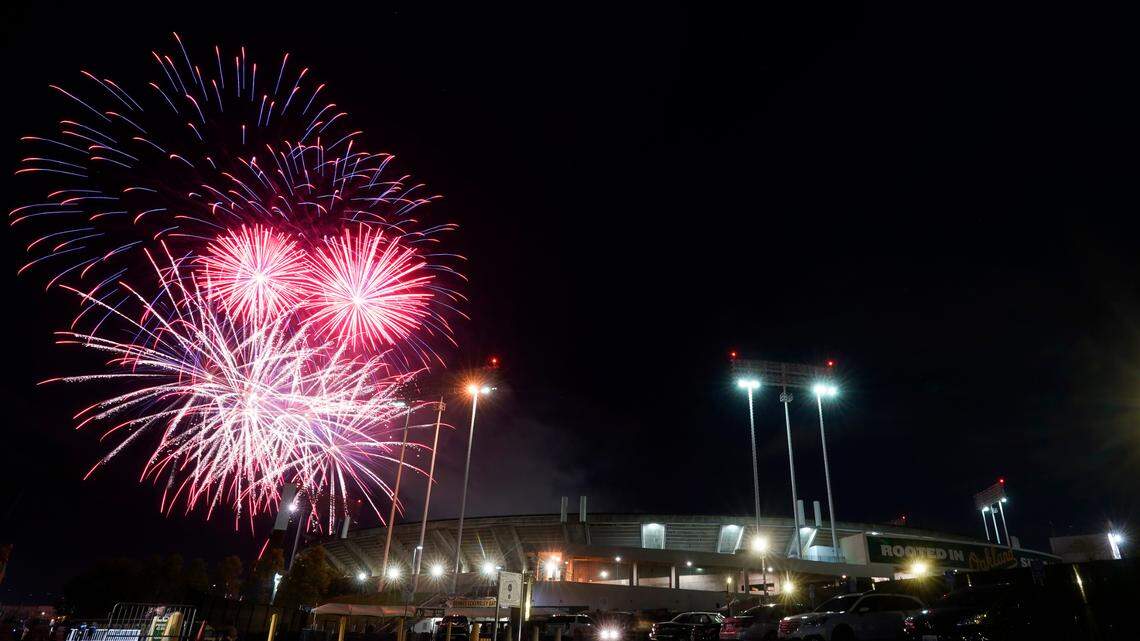 Fireworks erupt over RingCentral Coliseum after a baseball game between the Oakland Athletics and the Toronto Blue Jays on Monday, July 4. Four people at the coliseum were injured by bullet fragments from “celebratory gunfire” in the city, police say.