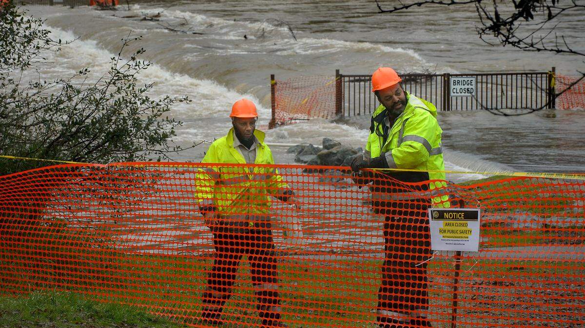 Sacramento County Regional Parks workers install barriers at the foot bridge over the American River just below Sunrise Blvd in Fair Oaks on Thursday, January 12, 2017. Open entry-level Sacramento County jobs include maintenance, food service and disability assistant work.
