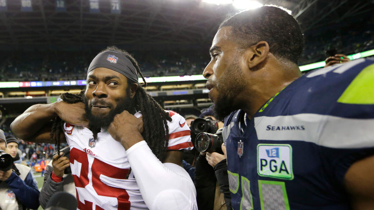 Richard Sherman, a cornerback with the 49ers, shares a light moment with Seattle Seahawks middle linebacker Bobby Wagner after a game Dec. 2 in Seattle. The two were teammates with the Seahawks before Sherman joined the 49ers this past offseason.