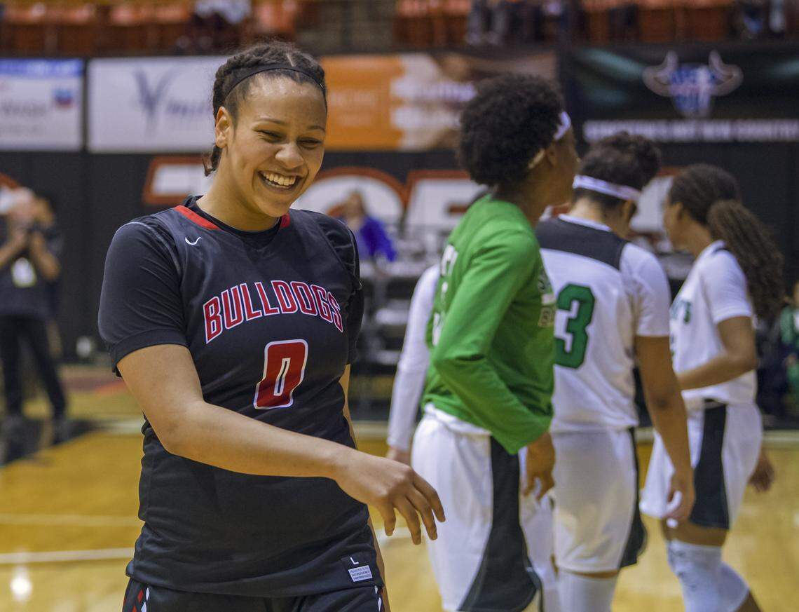 Folsom senior McKenzie Forbes laughs after joking with players and friends from St. Mary's after her Bulldogs lost 71-48 to the Rams in the Sac-Joaquin Section Division I championship game Saturday at Pacific.