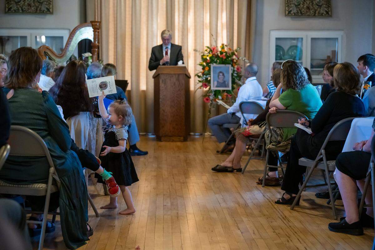 Paisley Jo Lake, 1½, holds the program for her late grand-aunt Machelle Wilson during her crowed memorial service at the Woman’s Club of Lincoln earlier this month. Wilson was a UC Davis biostatistician who was hit by a car while crossing a Sacramento County street in October and died last month.