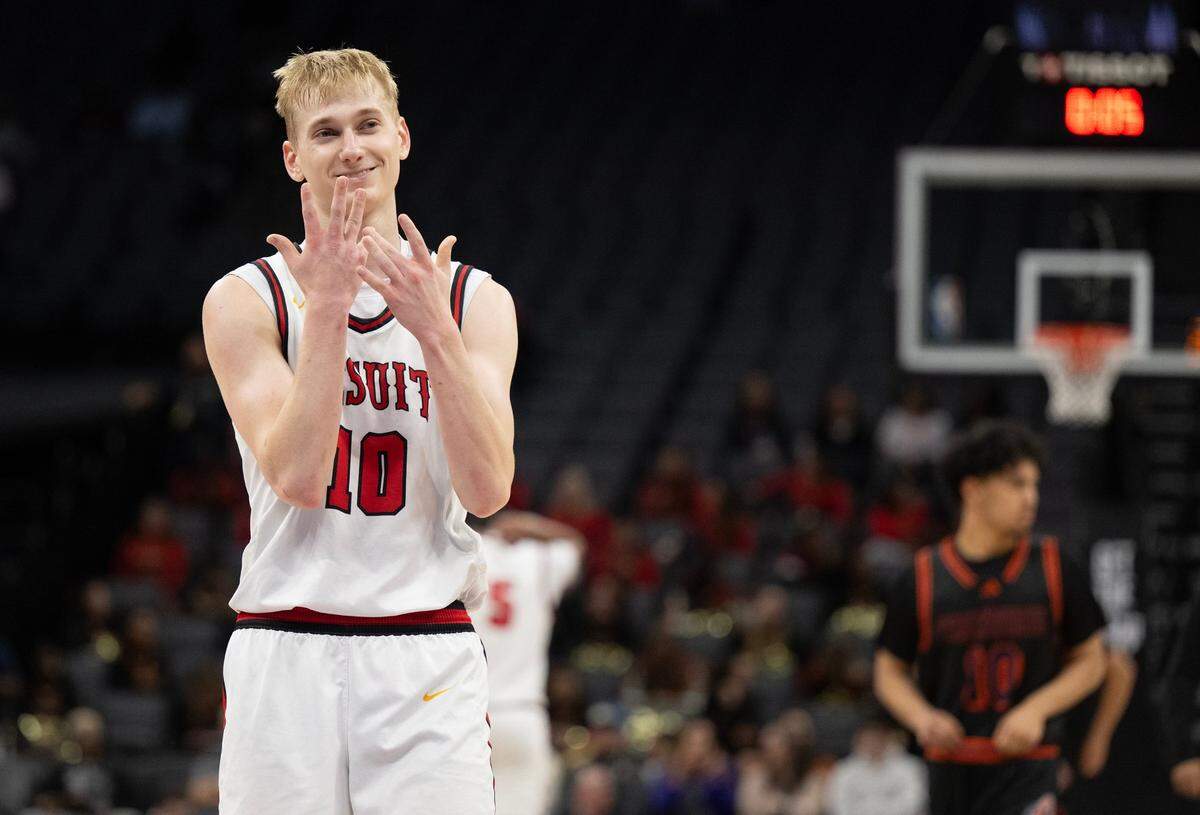 The Jesuit Marauders’ Luke Browne (10) points to his index finger, where his championship ring will live before shooting free throws late in the second half of the CIF State Division II boys basketball final against the Chatsworth Chancellors on Saturday at Golden 1 Center.