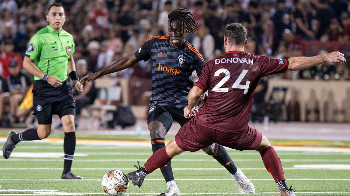 Sacramento Republic FC defender Conor Donovan (24) takes the ball away from Orange County SC forward Bryce Jamison (11) during the first half of the USL soccer game at Hughes Stadium on Saturday, Aug. 26, 2023, in Sacramento. Republic FC returned to the site of its first match for a 10th-season celebration.