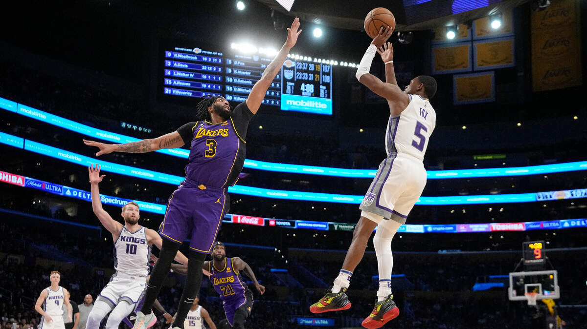 Sacramento Kings guard De’Aaron Fox, right, shoots as Los Angeles Lakers forward Anthony Davis defends during the second half of an NBA basketball game Friday, Nov. 11, 2022, in Los Angeles. (AP Photo/Mark J. Terrill)