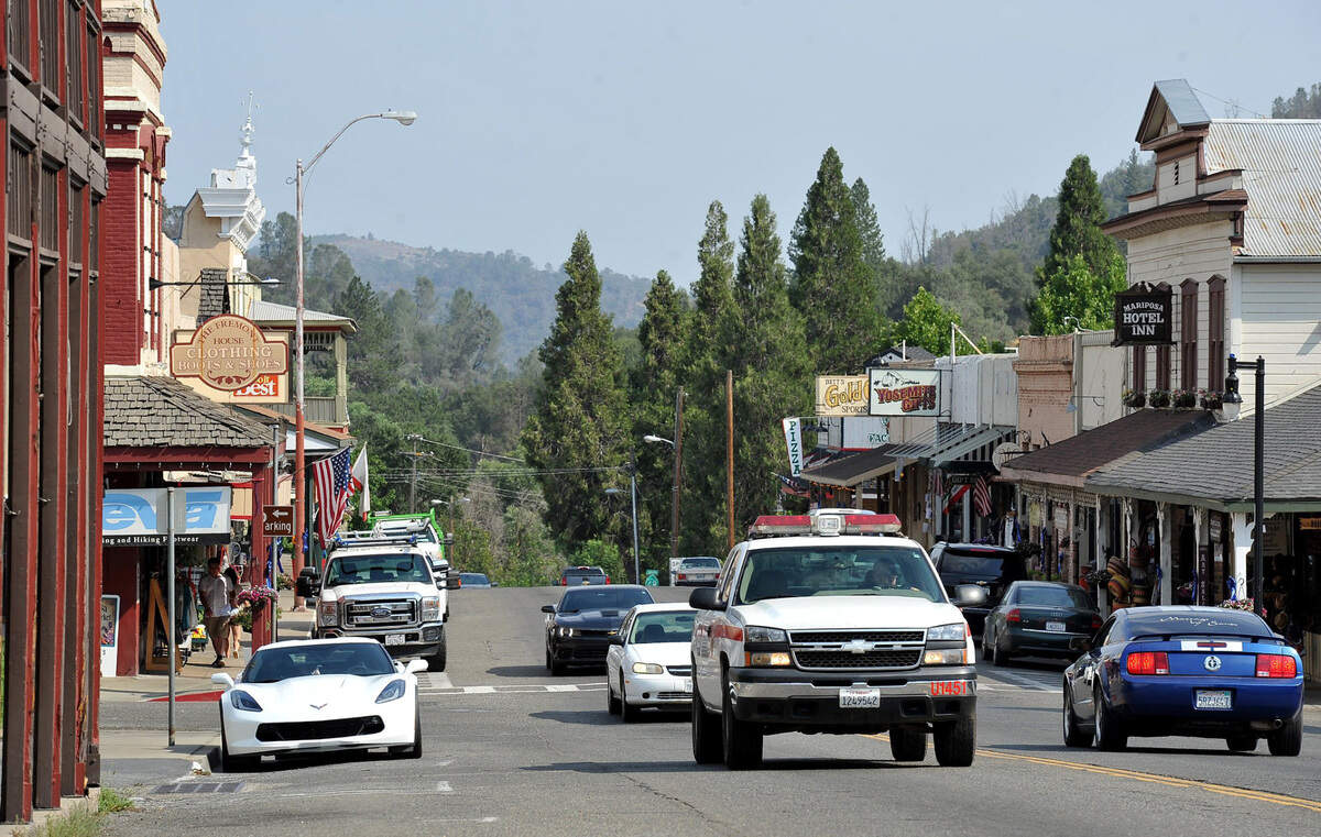 Vehicles drive down Highway 140 in downtown Mariposa, the county seat of Mariposa County, in 2017 after the Detwiler Fire. The county of 17,000 residents has no incorporated cities.