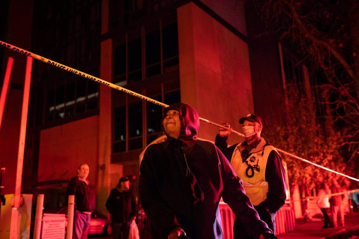 Alberteen Earl, 73, who has lived in the 12-story senior living tower at 626 I St. for eight years, is helped away from the building after being evacuated due to unsafe conditions following a power outage after a fire at a SMUD power substation earlier Tuesday.