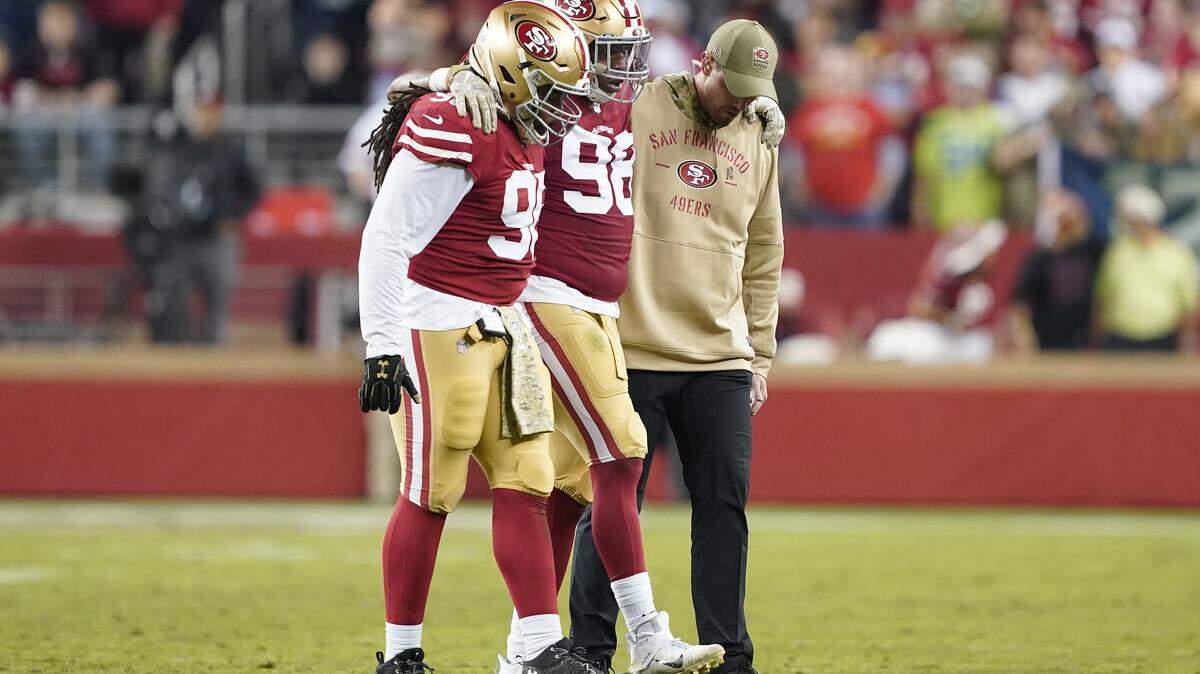 San Francisco 49ers defensive end Ronald Blair III, center, is helped off the field during the second half of an NFL football game against the Seattle Seahawks in Santa Clara, Calif., Monday, Nov. 11, 2019. (AP Photo/Tony Avelar)