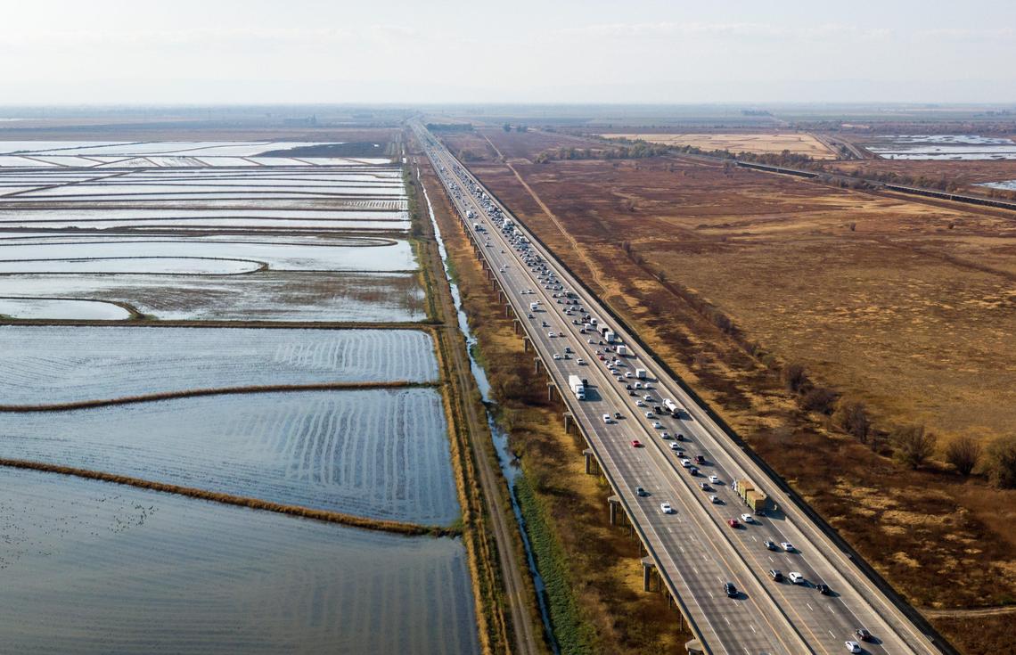 Westbound traffic on Interstate 80 slows on the Yolo Causeway in 2019. The elevated freeway crosses the Yolo Bypass, a vast floodplain that includes rice fields and protected wildlife habitat.