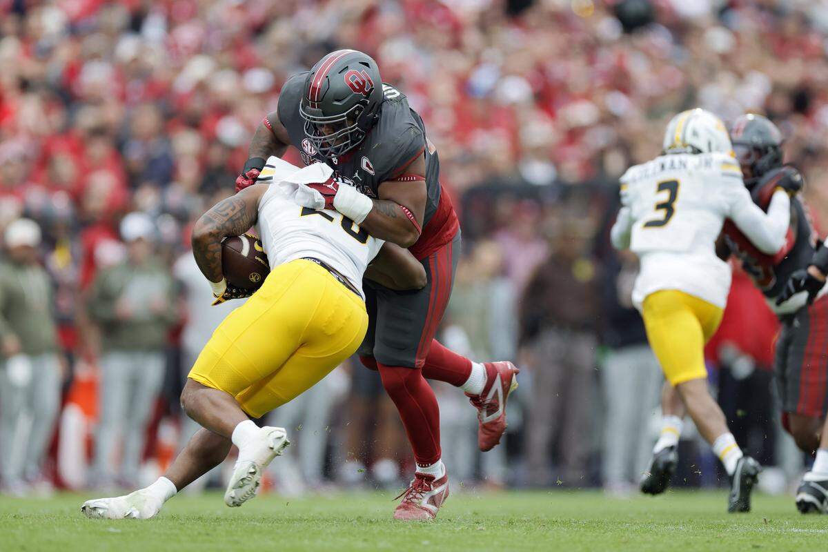 Defensive lineman Gracen Halton of the Oklahoma Sooners stops running back Jamal Roberts of the Missouri Tigers in the backfield for a 3-yard loss on 3rd-and-13 in the first quarter at Gaylord Family Oklahoma Memorial Stadium on Nov. 22 in Norman, Oklahoma.