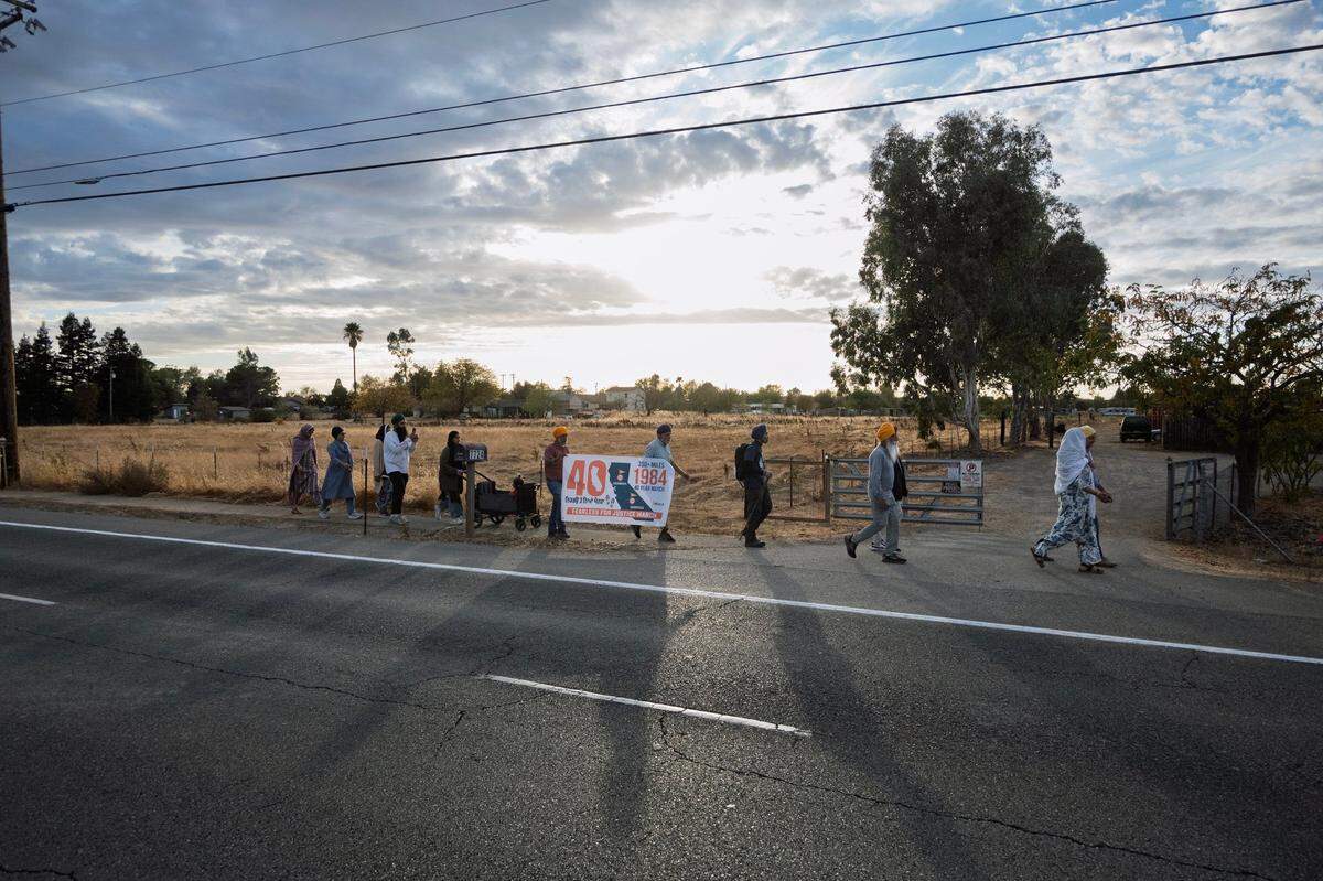 Punjabi Sikhs march Wednesday on Bradshaw Road toward the Gurdwara Sacramento Sikh Society in Vineyard to conclude a 16-mile trek from Lodi. The group started in Bakersfield on Oct. 9, with the goal of marching 350 miles in the Central Valley to mark the 40th anniversary of deadly anti-Sikh riots in India.