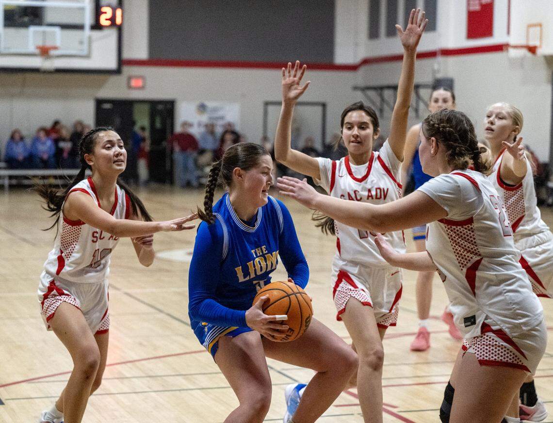 Faith Christian Lions’ Lauren Harris is triple-teamed in the first half against the Sacramento Adventist Capitals on Tuesday, Jan. 27, in Carmichael.