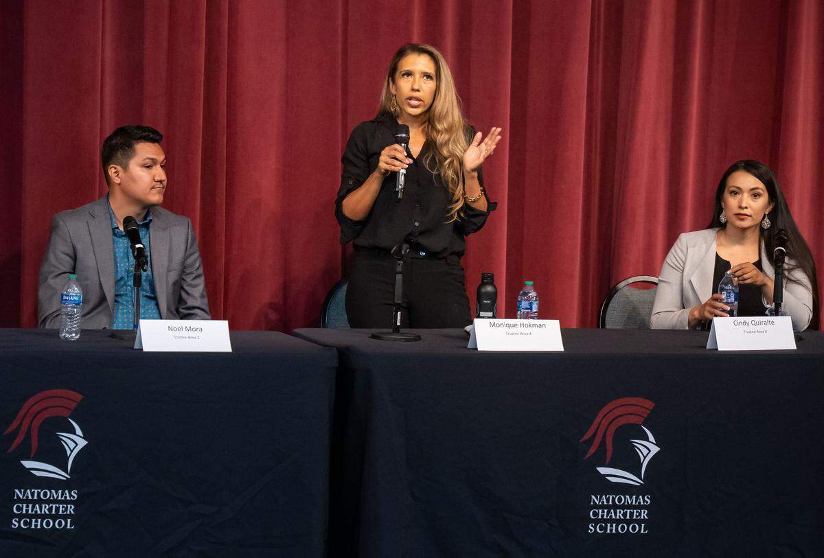 Natomas Unified School District board trustee candidate Monique Hokman, running against Area 4 opponent Cindy Quiralte, right, stands to answer a question posed at a candidate forum Wednesday, Oct. 12, 2022, at the Benvenuti Performing Arts Center adjacent to Natomas Charter School.