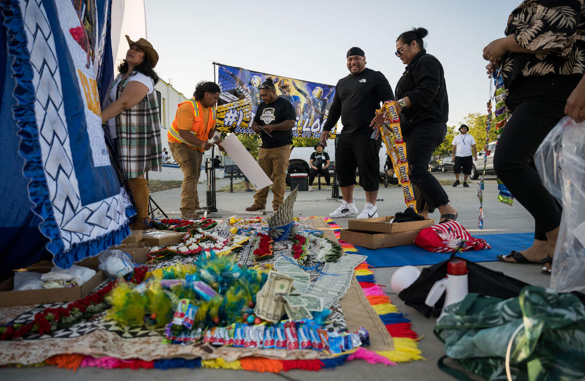 Dubee Lopa’s family set up to celebrate his graduation from Grant Union High School, Tongan style, as the ceremony takes place inside the stadium Thursday, June 1, 2023, in Sacramento’s Del Paso Heights neighborhood.