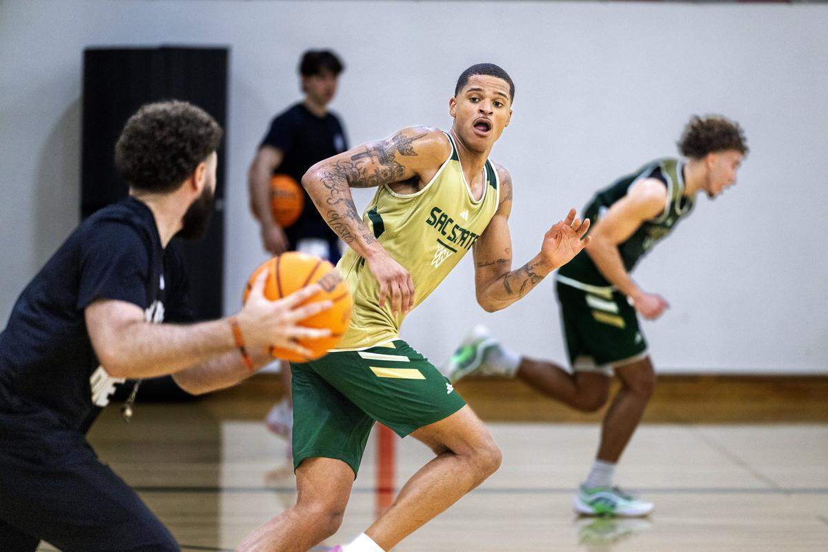 Sacramento State forward Shaqir O'Neal, son of NBA All-Star Shaquille O’Neal, prepares to take the ball from associate head coach Michael Bibby during practice last month.