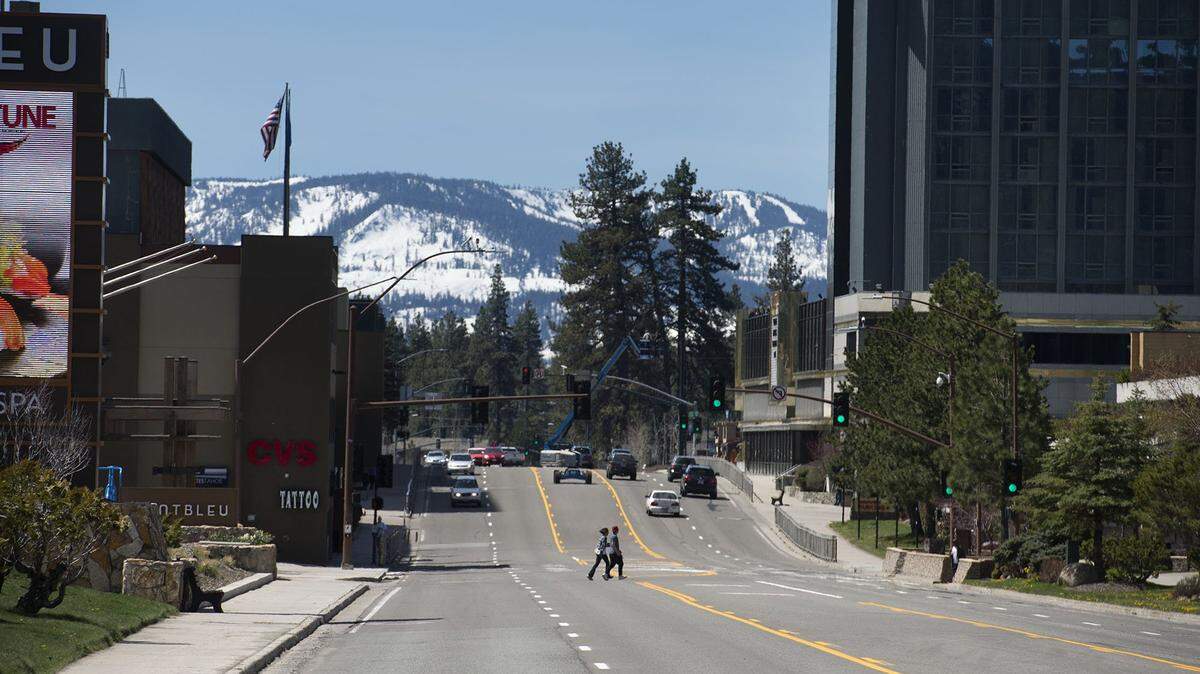 Two pedestrians cross Highway 50 in front of casinos in 2017.