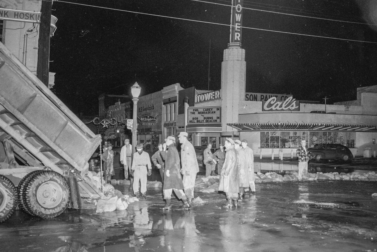 A truck dumps sandbags in downtown Marysville near the Tower Theater as workers prepare for the deluge in December 1955. 