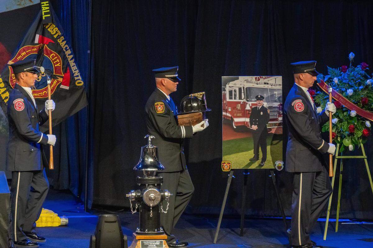 Members of the Honor Guard and West Sacramento Fire Department carry the ashes of Fire Engineer Tim Hall after a Last Alarm ceremony at Creekside Church in Elk Grove on Tuesday.