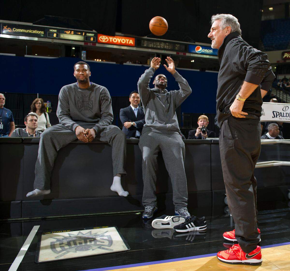 Sacramento Kings coach Paul Westphal, puts on DeMarcus Cousins size 16 shoes as teammate Tyreke Evans enjoys the moment during the Kings’ annual open scrimmage at Power Balance Pavilion on Dec. 15, 2011.
