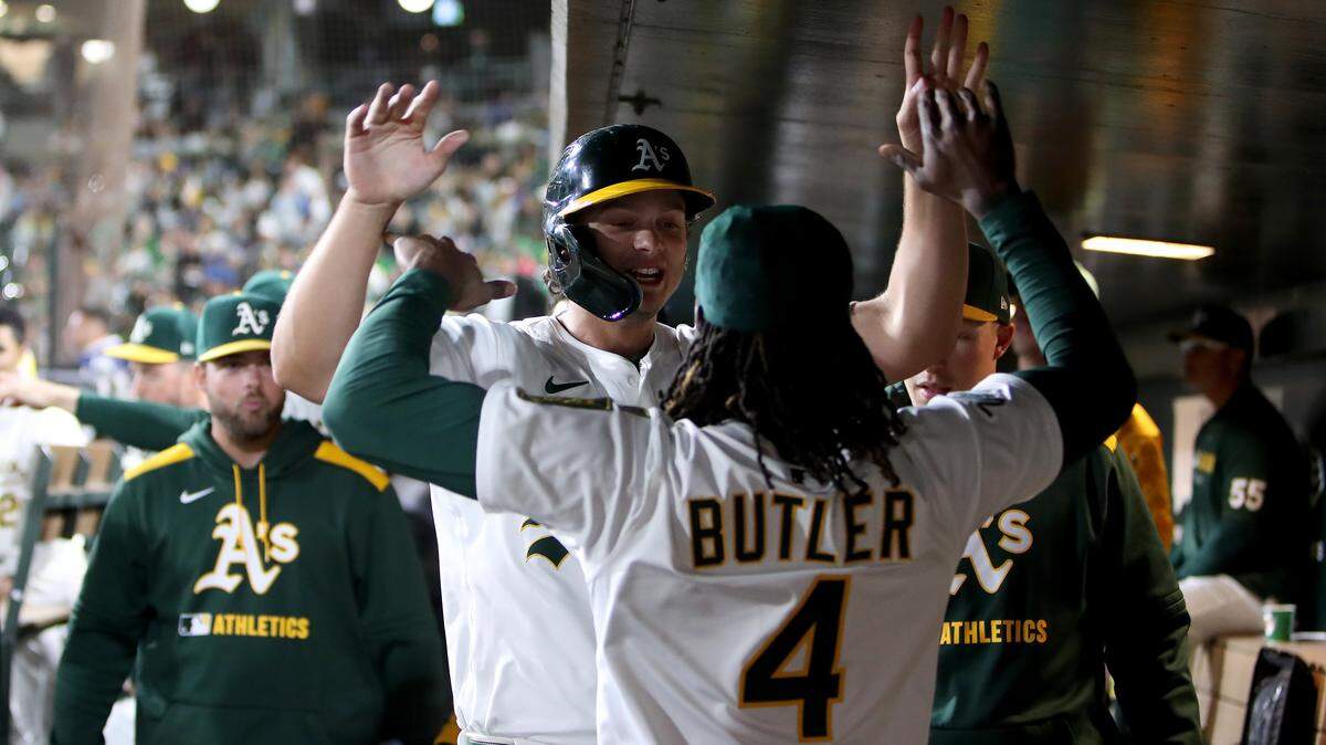 Sep 27, 2025; West Sacramento, California, USA; Athletics first baseman Nick Kurtz (16) is congratulated by center fielder Lawrence Butler (4) after scoring a run against the Kansas City Royals during the eighth inning at Sutter Health Park. Mandatory Credit: Dennis Lee-Imagn Images