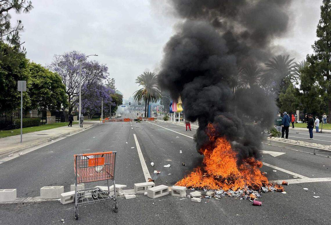 People block off Alondra Boulevard and set a fire during protests against ICE and immigration raids on Saturday, June 7, 2025, in Paramount. Gov. Gavin Newsom condemned the announced federal deployment of National Guard troops to the area Saturday, calling it “purposefully inflammatory” and warning it would “erode public trust.”