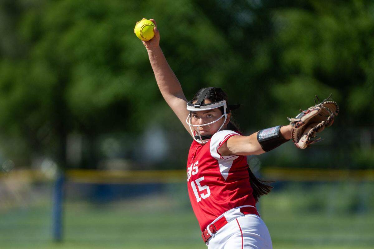 McClatchy Lions pitcher Madelyn Ogata pitches against the Folsom Bulldogs during a first-round Sac-Joaquin Section Division I softball playoff game at Folsom High School on Wednesday in Folsom.