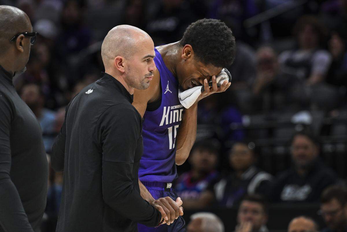 Sacramento Kings forward De'Andre Hunter (15) is helped off the court after he was injured during a game against the LA Clippers at Golden 1 Center on Friday, Feb. 6, 2026.