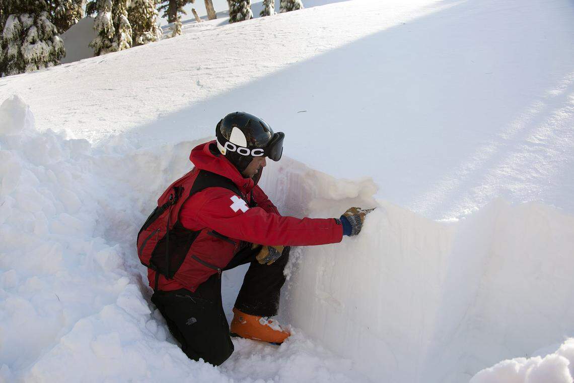 Will Paden, director of avalanche control at Squaw Valley ski resort kneels inside a snow profile pit where he can observe the layers of snow and how they bind together giving him a better understanding of how to prevent avalanches on Monday, February 1, 2016, in Squaw Valley, Calif.