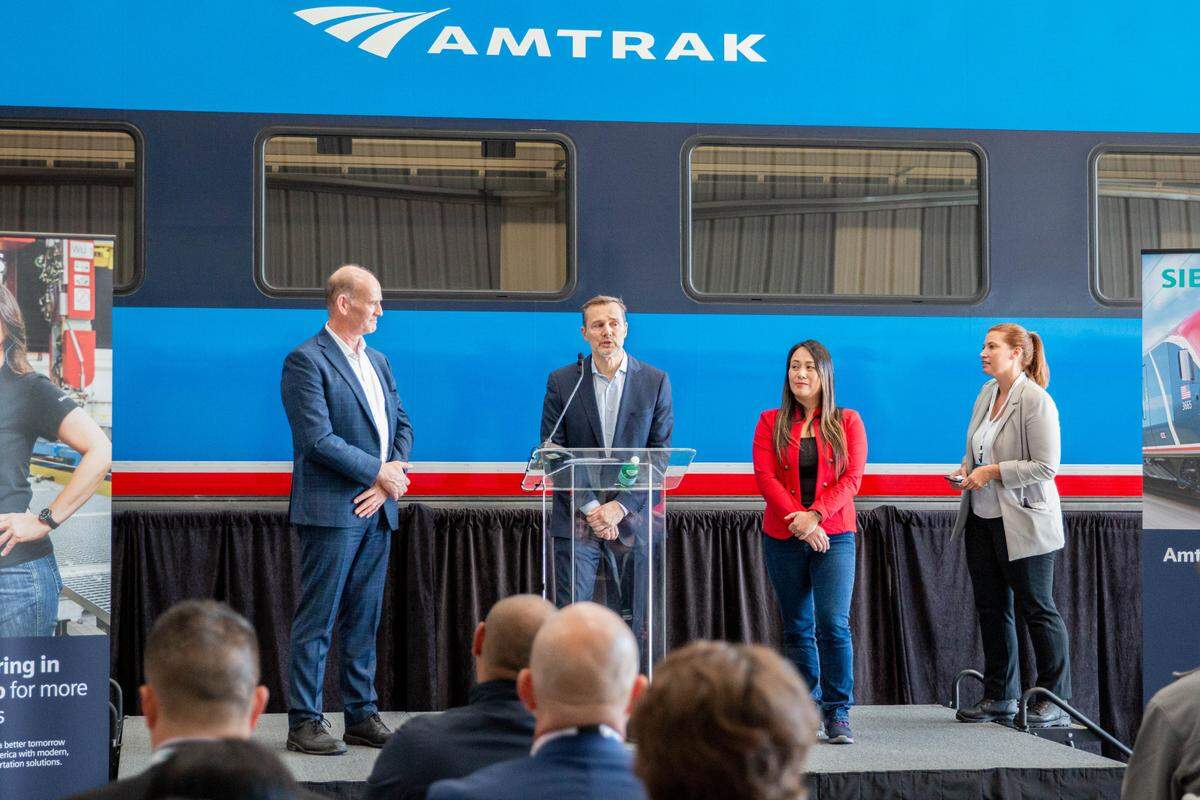 Amtrak President Roger Harris speaks in front of the first Amtrak Airo train car at the Siemens Mobility manufacturing facility in Sacramento on Wednesday.